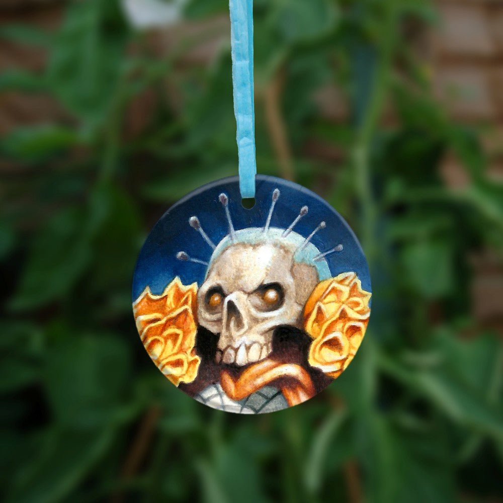 The reverse side of the ornament, showing just one skull.