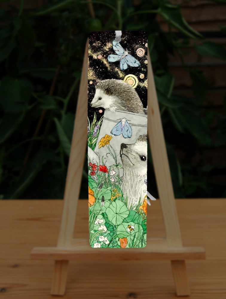 It's night-time and two hedgehogs are playing in a flowerbed. One sits amongst orange and red blooms. Behind him, the other is climbing out of a large watering can. Blue moths sit on the watering can and flitter overhead.