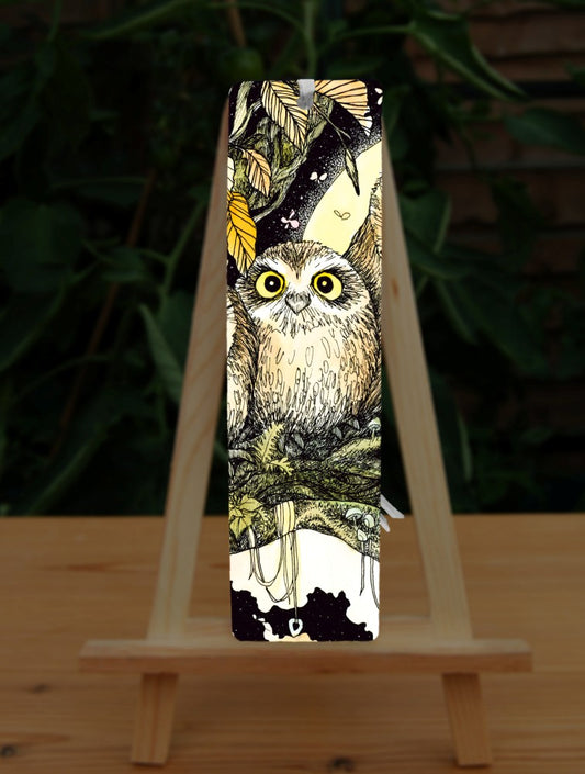 An owl sits on the branch of a tree looking towards the viewer. Brown leaves splay down from above. Offerings are wrapped around a branch below him.