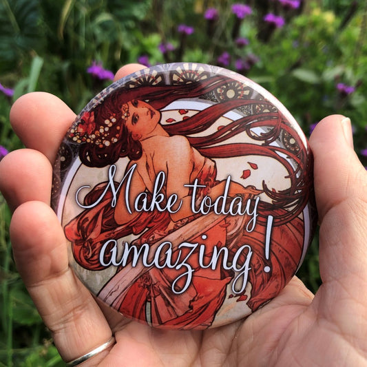 Art Nouveau style image of a young woman with long red hair and wearing a long, flowing red dress. She is leaning back and turned away from the viewer, looking back over her shoulder. Colours are reds and browns. "Make today amazing!" is written in decorative white text over the centre of the design.
