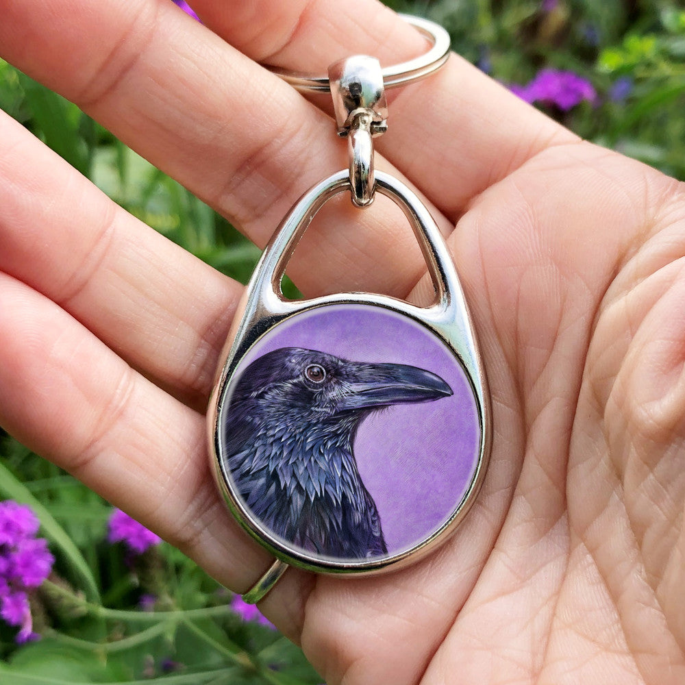 A side view of the head and neck of a raven with lots of feather detail. The raven is coloured black with purple shading, and the background is mottled purple.