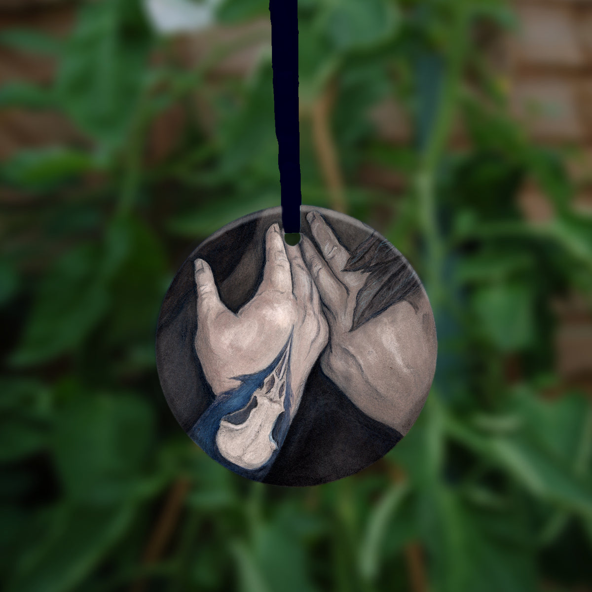 The second side of the ornament showing a close-up of her hands