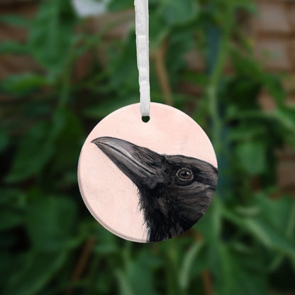 The reverse side of the ornament showing a close-up of the raven's head.