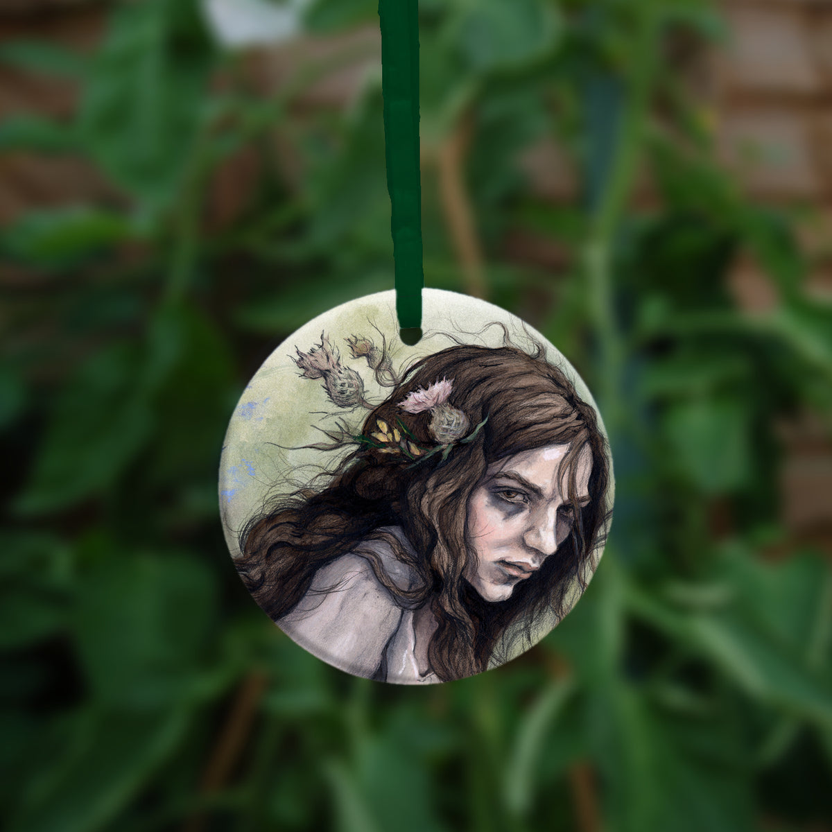 The reverse side of the ornament, showing a close-up of the woman's head.