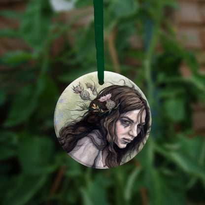 The reverse side of the ornament, showing a close-up of the woman's head.