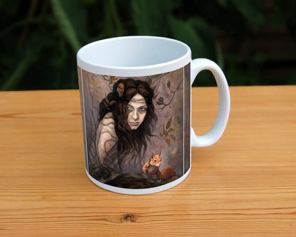 White ceramic mug: The head and body of a young woman appears above a thick tree branch, upon which sits a red squirrel. Two more squirrels crouch on a branch above her. The woman is turning her head as if to look behind her. She has long brown hair with leaves stuck in it. Autumnal leaves and branches fill the scene. Colours are reds, oranges and browns.