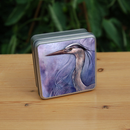 A square tin: A sideways view of the head and neck of a heron. The background is a mottled purple with a swirl pattern.