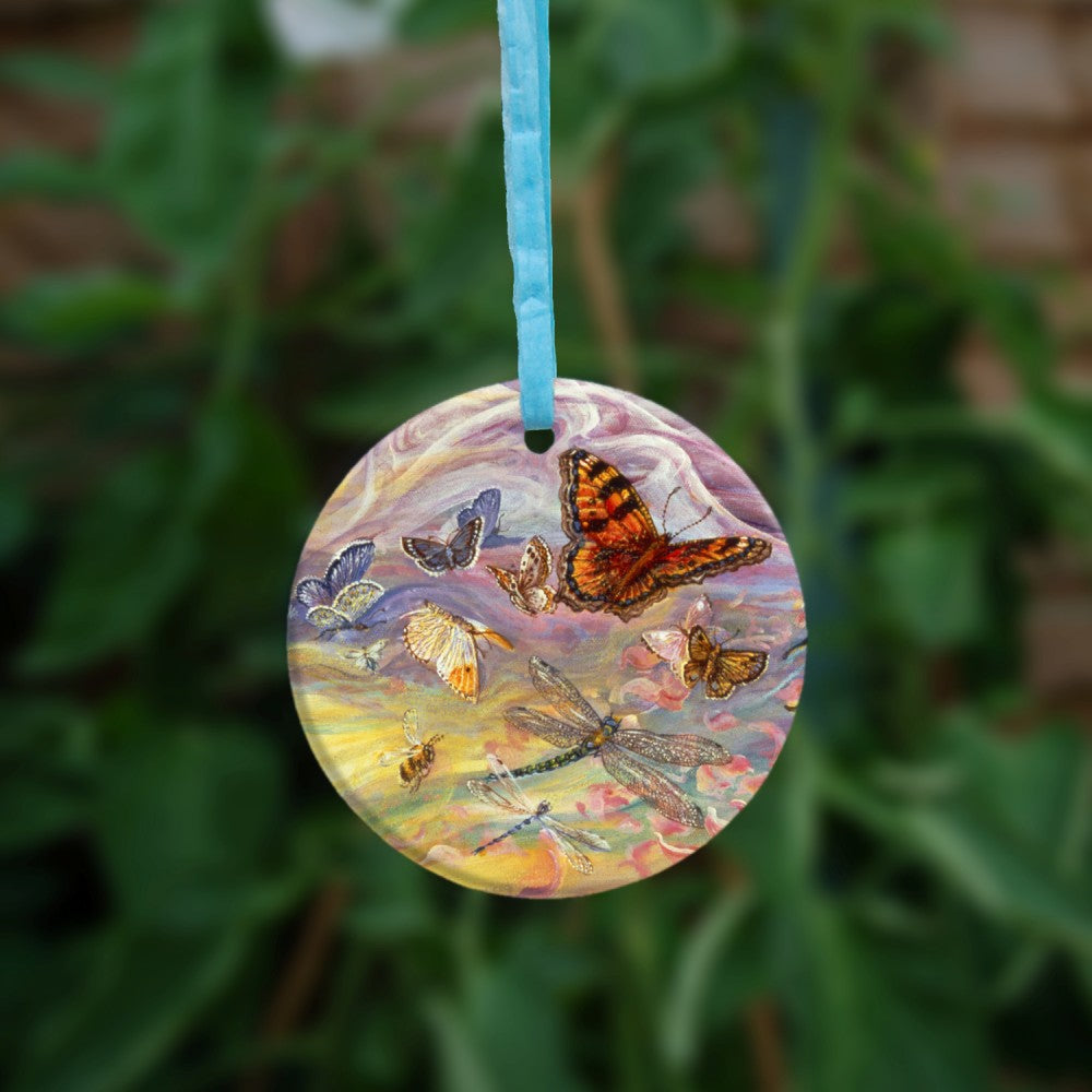 The reverse side of the pendant. Butterflies and dragonflies in flight.