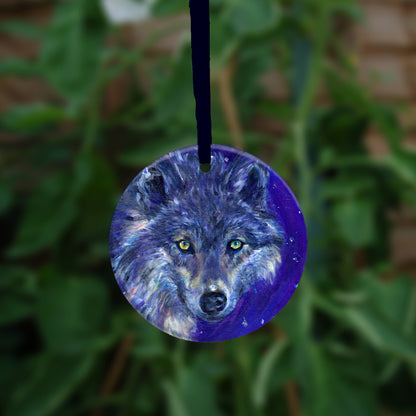 The head of a wolf, looking directly at the viewer. The overall colour of both the wolf and the background are shades of blue, with the exception of yellow/green eyes and flashes of paler fur around the neck.