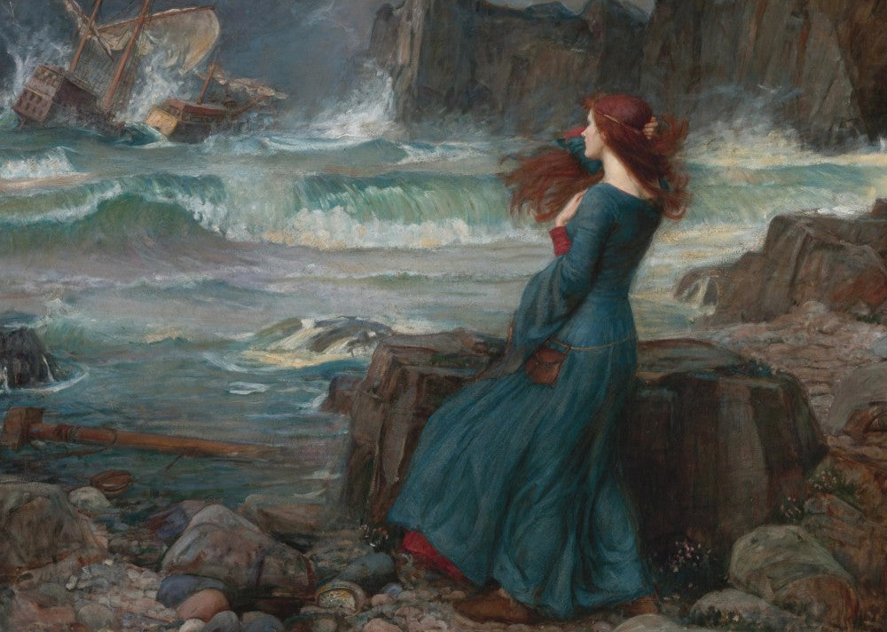 A woman with long red hair and wearing a long dark blue dress, holds her hair back in the wind as she stands on a rocky shore looking out to sea. The sea is stormy. Large rollers break onto the shore, and a little way out, a large old-fashioned ship, its sail torn, is smashed against rocks.