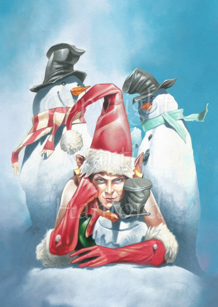 An elf is lying on snow propped up on his elbows, facing the viewer. He's wearing a red and white santa hat and long red gloves. He has a rather grumpy expression. In the space between his elbows is the head of a snowman with a long carrot nose and wearing a black top hat. Behind him stand two smiling snowmen, also with black top hats and carrot noses, and scarves.