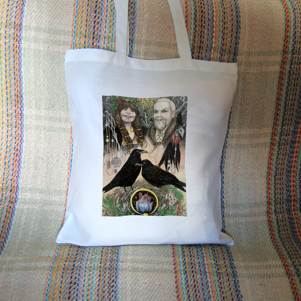 The head and shoulders of a woman (on the left) and a man (right) stand together, facing the viewer. The woman has long, plaited and bound brown hair, three drawn lines from her lip to her neck, and wears a garland on her head. To her side sits a delicate staff with runes hanging from it. The man has just one eye, with a long scar going vertically through where it should be, and is wearing a fur coat. A shaman's rattle, with the appearance of being made from a raven's head and feathers ...