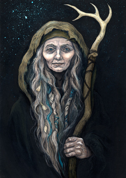 An older woman with blue eyes stands facing the viewer. Her head is covered by a brown hood, and her long grey hair, some of it braided with blue braid, falls down below her face. She holds a staff, topped with a deer antler, upright in one hand. A sea of stars shine behind her.