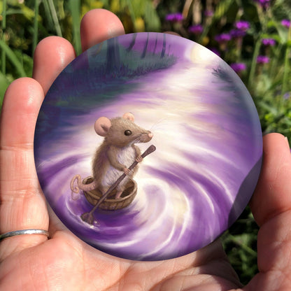 A cute brown mouse, standing in half a nut shell and holding a twig shaped like an oar, drifts down a stream towards a bright light. Trees line either side of the stream. Colours are purples and greens.