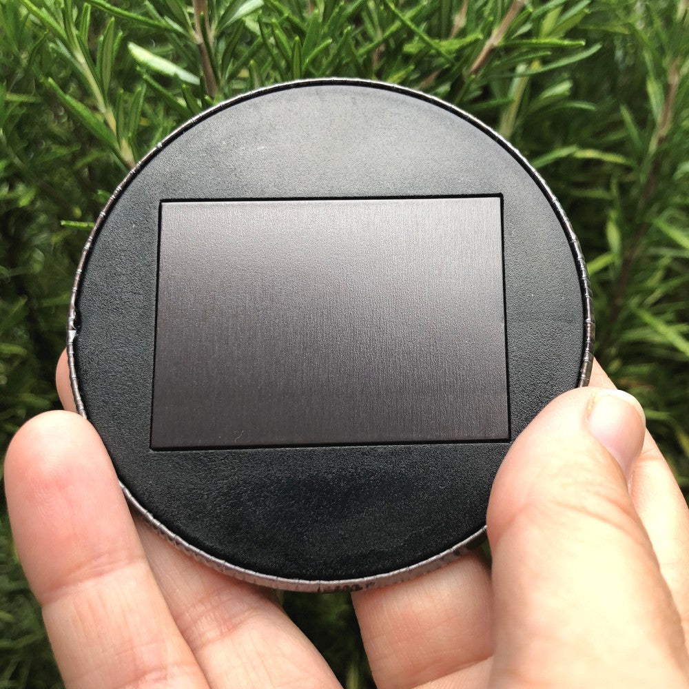 Magnet side. The back is entirely black with a large rectangular magnet in the middle.